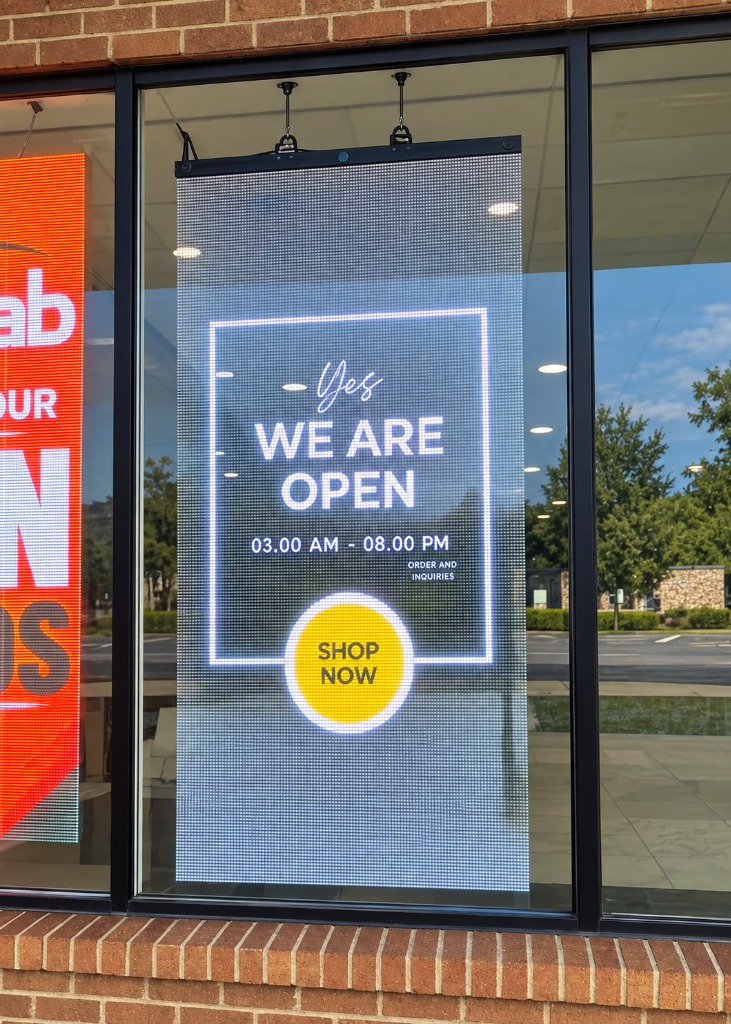 Cabinet-style transparent LED screen installed in a storefront window