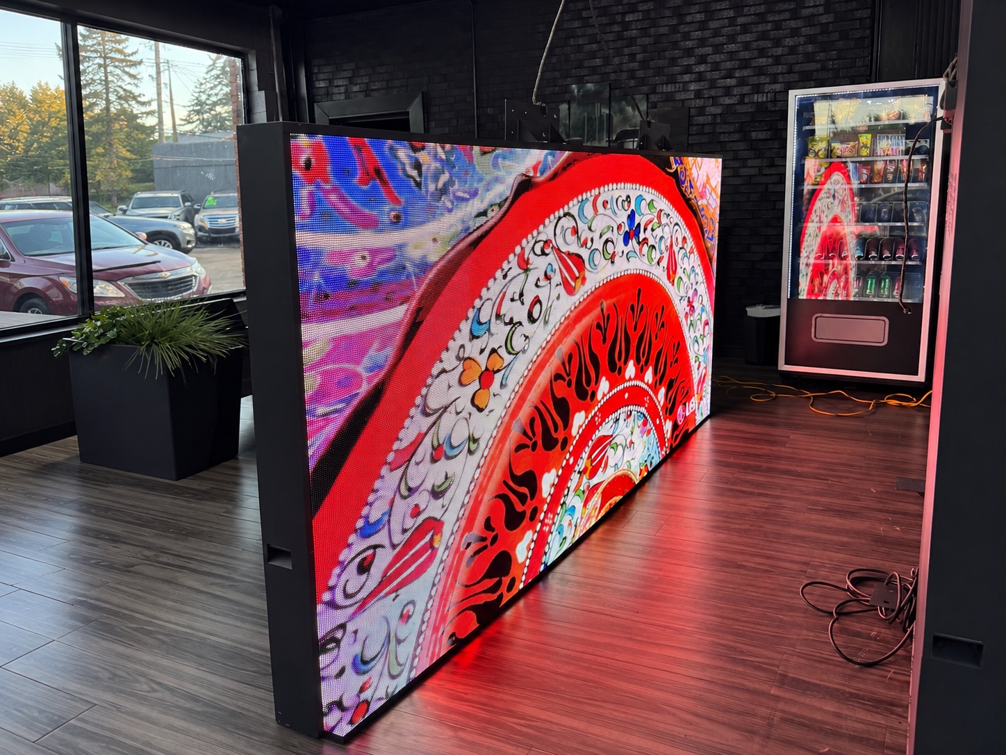 Angled view of the Greenfield Motors indoor LED display during content testing