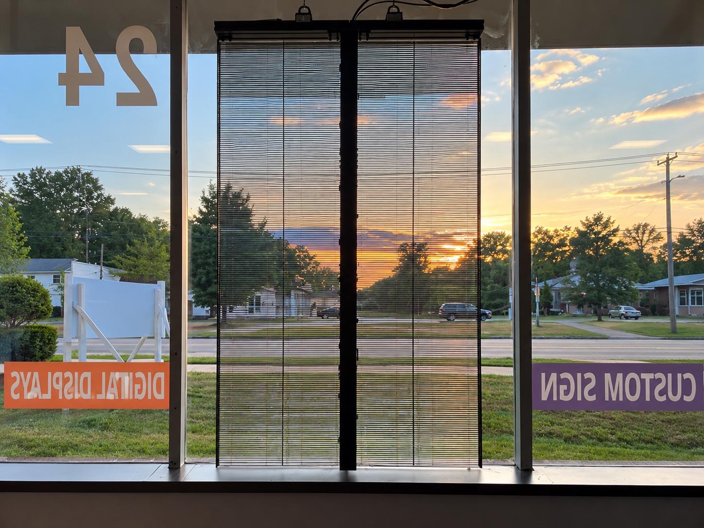Interior transparency view through the SignLab Troy LED window display at sunset