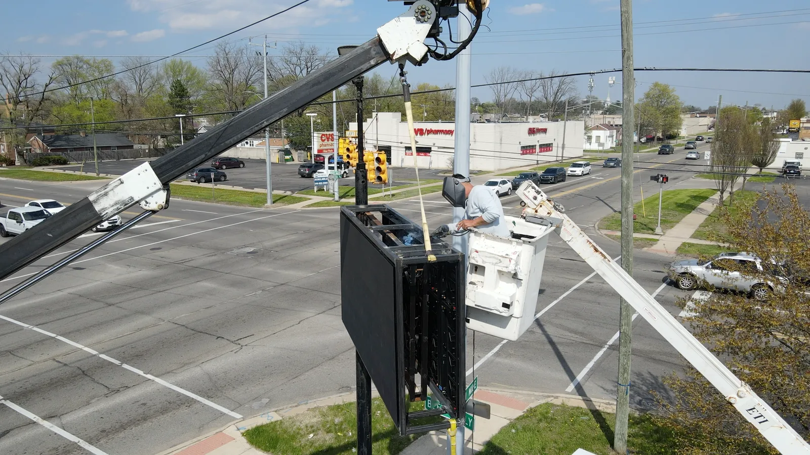 Technician installing the Zazen outdoor LED pole sign in Redford, Michigan