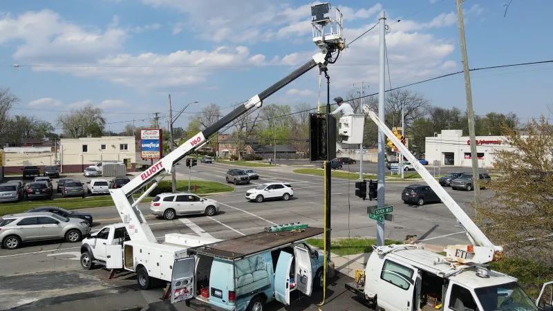 Crane lifting an outdoor LED sign during a PixaClear project in Redford, Michigan